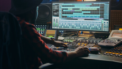 Fototapete - Music Creator, Musician, Artist Works in the Music Record Studio, Uses Surface Control Desk Equalizer Mixer. Buttons, Faders, Sliders to Broadcast, Record, Play Hit Song. Close-up Shot