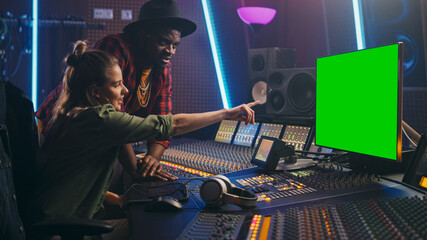 Producer and Audio Engineer Working together in Music Record Studio on a New Album, Use Green Screen Computer, Control Desk for Mixing and Creating Hit Song. Artist and Musician Collaboration