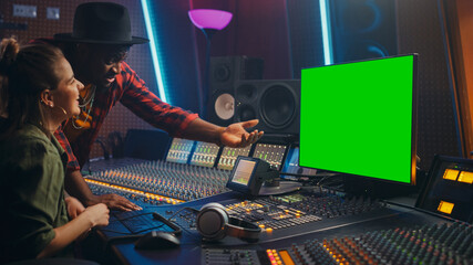 Fototapete - Producer and Audio Engineer Working together in Music Record Studio on a New Album, Use Green Screen Computer, Control Desk for Mixing and Creating Hit Song. Artist and Musician Collaboration