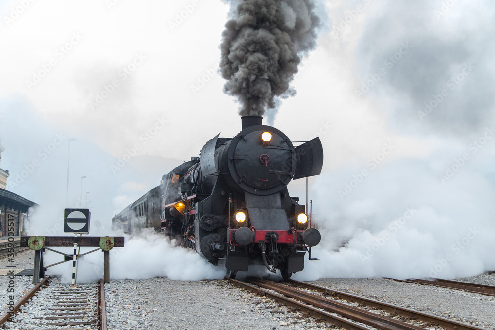 Old steam train - locomotive leaves the Nova Gorica railway station - obrazy, fototapety, plakaty 