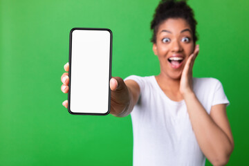 Wall Mural - Girl showing white blank cell phone screen at studio