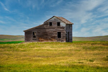Old Abandoned Farm House In Prairie.