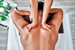canvas print picture - Handsome man relaxing and enjoying a deep tissue back massage at the spa salon.