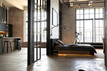 luxury studio apartment with a free layout in a loft style in dark colors. stylish modern kitchen ar