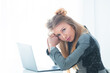 © Yarkovoy - Business woman in a strict business suit works in an office at a desk on a laptop