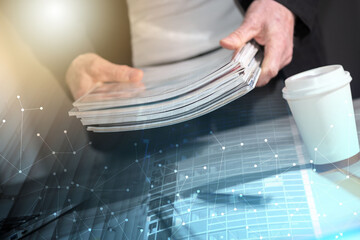 Male hands holding magazines; multiple exposure