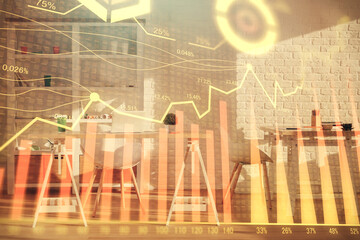 Double exposure of financial graph drawing and office interior background. Concept of stock market.