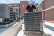 © spatesphoto - Moving a new air conditioner for an install