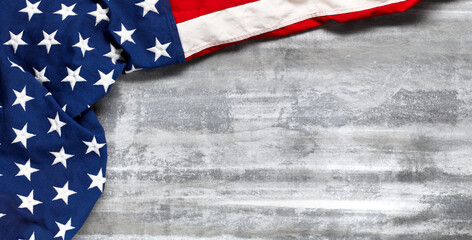 US American flag on worn white wooden background. For USA Memorial day, Veteran's day, Labor day, or 4th of July celebration. With blank space for text.