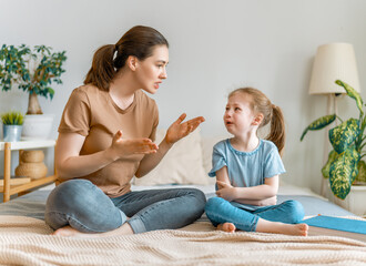 mother is scolding her child girl.