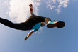 © arthurhidden - Low angle view of a sportsman who jump and run with blue sky in background
