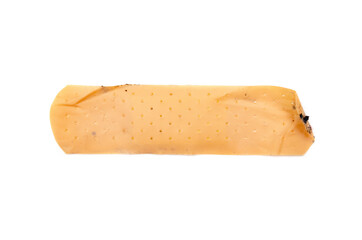 used antibacterial patch on a white background in macro. dirty patch, orange yellow top and side vie