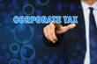 © New Africa - Corporate tax concept. Man touching virtual screen on color background, closeup