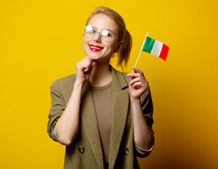 Wall Mural - Style blonde woman in jacket with Italian flag on yellow background