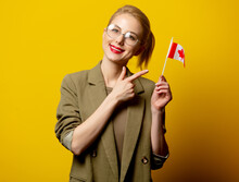 Style Blonde Woman In Jacket With Canadian Flag On Yellow Background