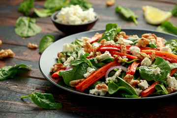 Roasted carrot salad with feta cheese, walnut and spinach. healthy food