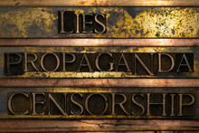 Lies Propaganda Censorship Text Formed With Real Authentic Typeset Letters On Vintage Textured Silver Grunge Copper And Gold Background