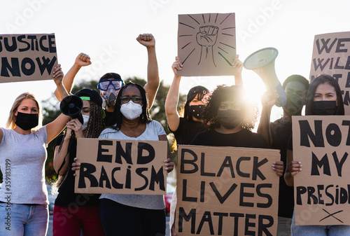 Plakat People from different culture and races protest on the street for equal rights - Demonstrators wearing face masks during black lives matter fight campaign - Focus on black woman face