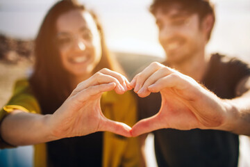 Wall Mural - Travel, tourism - couple make a heart with two hands couple make a heart with two hands.