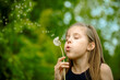 © irishasel - Summer in the park or forest. nature, freshness idea and freedom. happy childhood.Summer joy, little girl blowing dandelion at sunset near the river