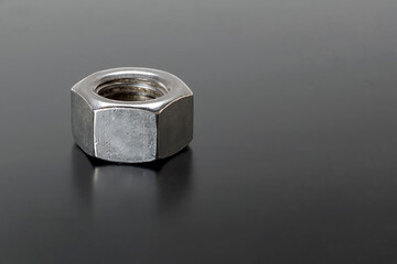 Steel nut metric threads on a gray background