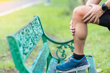 Wall Mural - Young adult male with muscle pain during running. runner have knee ache due to Runners Knee or Patellofemoral Pain Syndrome, osteoarthritis and Patellar Tendinitis. Sports injuries and medical concept