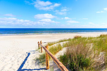 Wall Mural - Entrance to beautiful white sand beach with dunes and blue sea near Kolobrzeg, Baltic Sea coast, Poland