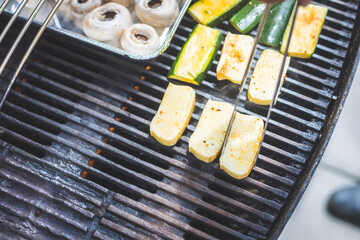 BBQ on weekend. Grill cheese and vegetables on gas grill. Outdoors.