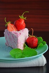 Wall Mural - A piece of cake with strawberry cream, sprinkled with coconut shavings.Fresh strawberry.