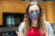 © Mat Hayward - Young woman wearing protective mask at home to prevent spread of covid-19, coronavirus