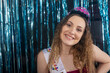 © Mat Hayward - Teenage girl with a big smile during her birthday party. Wearing a tiara and sash in front of a tinsel background.