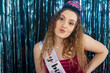 © Mat Hayward - Teenage girl with long, curly hair wearing a tiara and sash during her birthday party