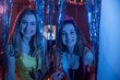 © Mat Hayward - Two smiling girls having fun together posing for a photo during a birthday party. Birthday girl is wearing a tiara and sash in front of a tinsel background for decoration