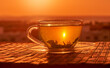 Tea cup with tea leaves in sunset. 