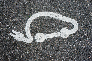 Closeup of electric car station sign on the floor in the street