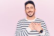 © Krakenimages.com - Young hispanic man wearing casual clothes smiling with hands on chest with closed eyes and grateful gesture on face. health concept.
