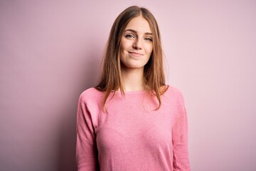 Wall Mural - Young beautiful redhead woman wearing casual sweater over isolated pink background looking sleepy and tired, exhausted for fatigue and hangover, lazy eyes in the morning.