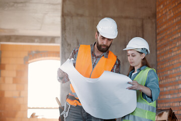 Wall Mural - A factory worker and an engineer make an inspection. Factory worker and business woman on the production line discussing the work plan