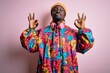 © Krakenimages.com - Young handsome african american man wearing colorful coat and cap over pink background relax and smiling with eyes closed doing meditation gesture with fingers. Yoga concept.
