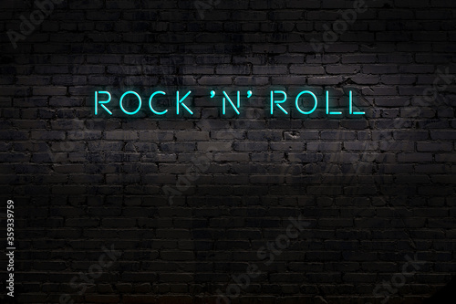 Fotomural Neon sign. Word rock 'n' roll against brick wall. Night view