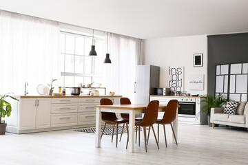 Stylish interior of modern kitchen with dining table