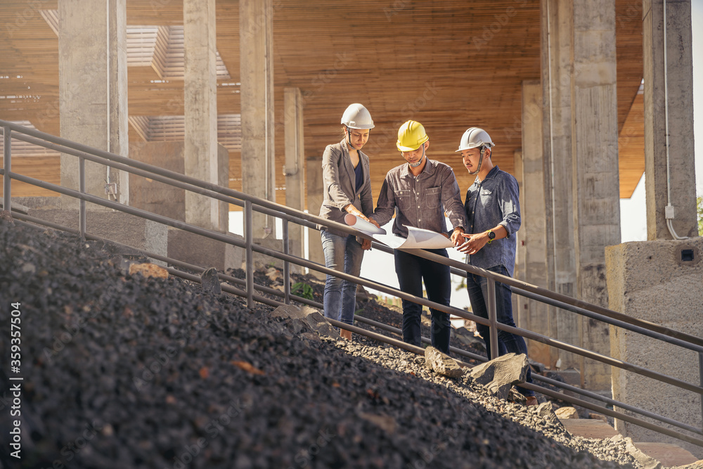 Structural Engineer At Work Structural engineer and architect working with blueprints discuss at ...