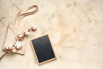 Eco bag with cotton flowers and frame on light background