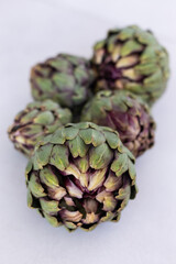 Minimalistic image ofartichokes on a light gray neutral backgrou