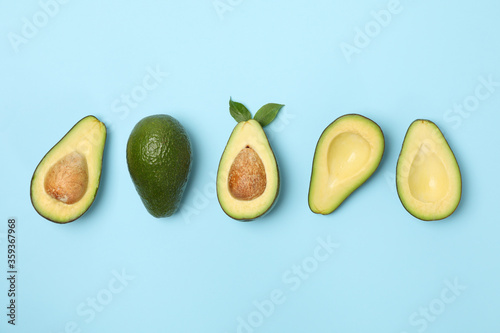 Fotografía Ripe fresh avocado on blue background, top view