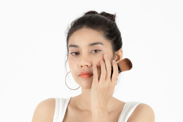 Healthy and cosmetics concept. Beauty face of young Asian woman applying make up with brush over white isolated background.