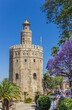 Golden tower at the riverbank park in Sevilla, Spain