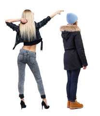 Wall Mural - Back view of two pointing young girl in winter jacket.