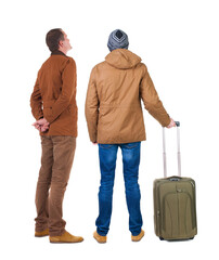 Poster - Back view of two man in winter jacket traveling with suitcas.