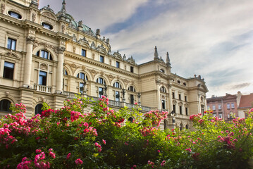 Wall Mural - Slovak Drama Theater in Krakow, Poland. 19th century building. Part of the building among rose bushes